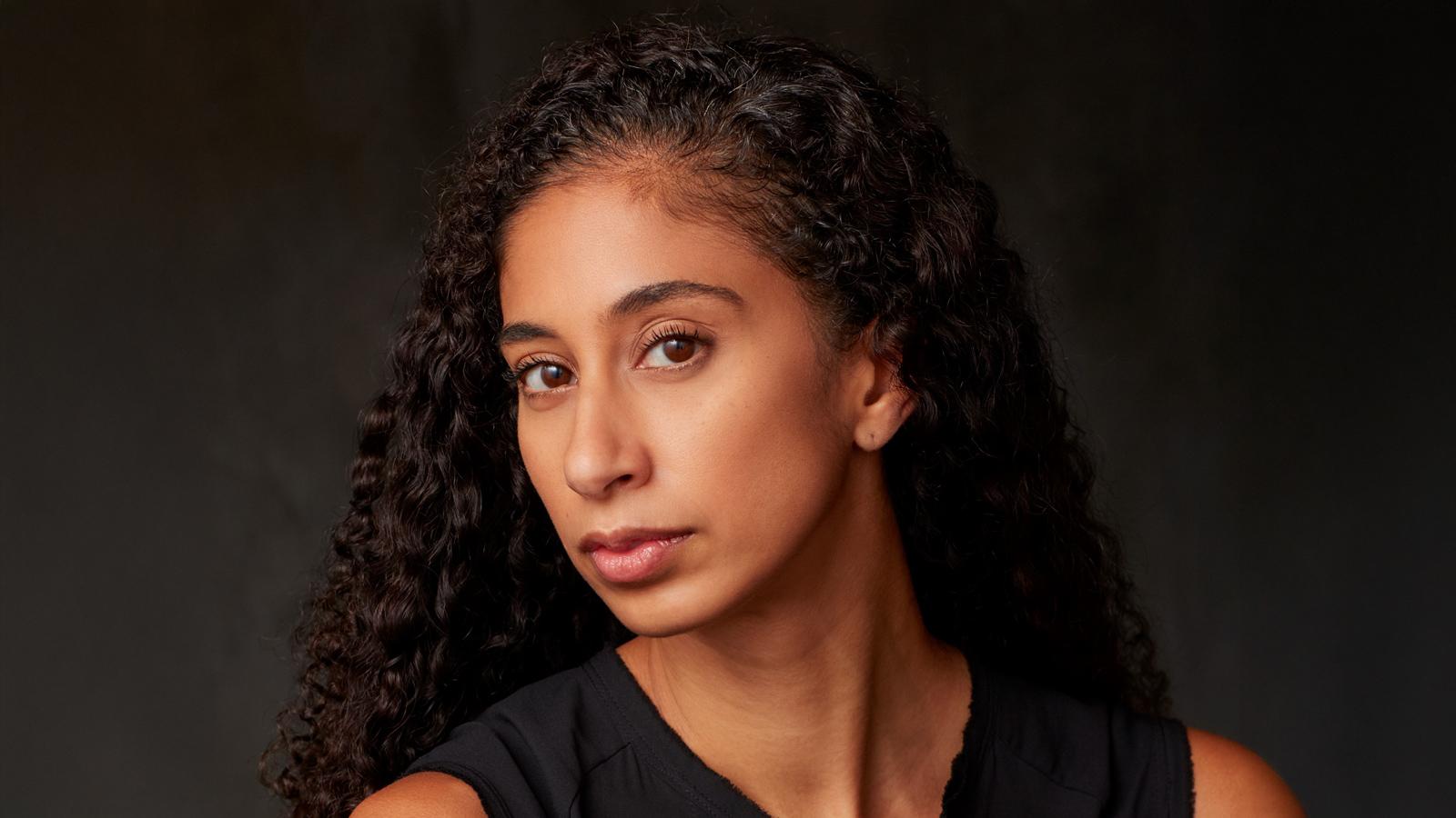 A headshot of Alicia Graf Mack in a black shirt