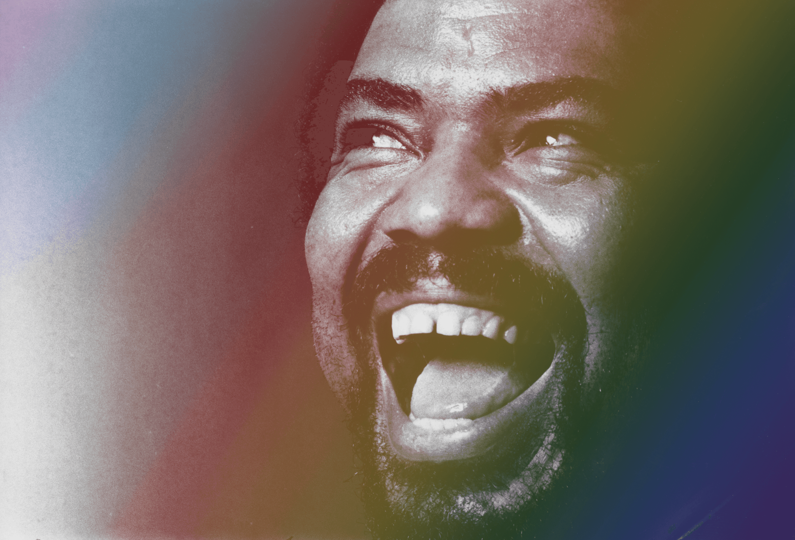 Alvin Ailey smiling with the Progress Pride flag colors overlaid